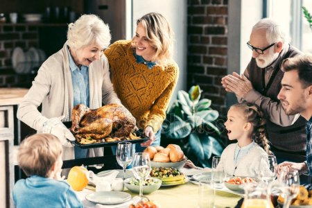 Thanksgiving depositphotos_170113010-stock-photo-family-having-holiday-dinner